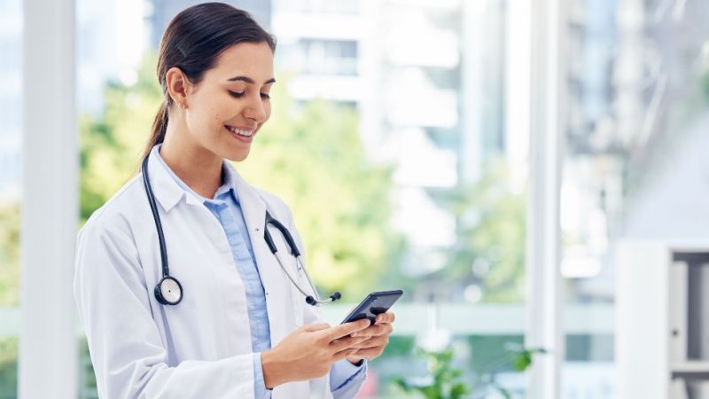 Female doctor using phone