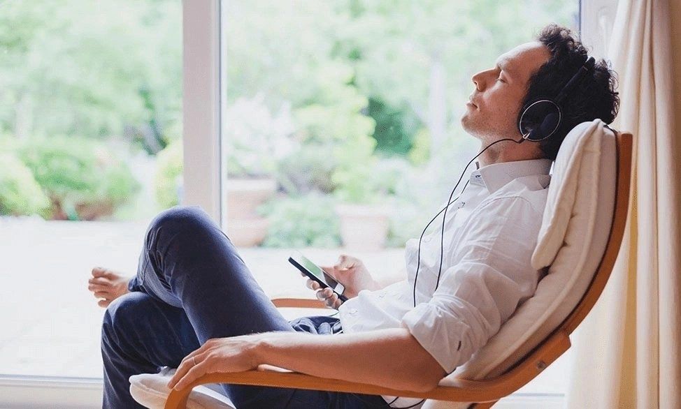 man listening on device